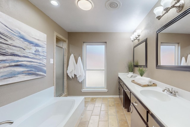 bathroom with vanity and separate shower and tub