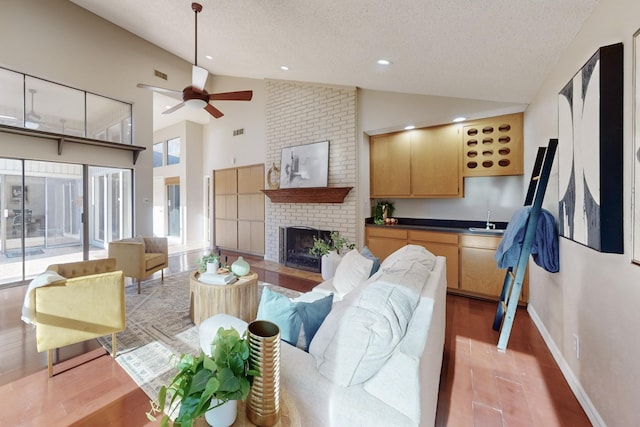 living room featuring a wealth of natural light, hardwood / wood-style floors, and a fireplace