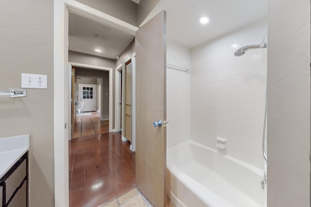 bathroom with tiled shower / bath, vanity, and tile patterned floors