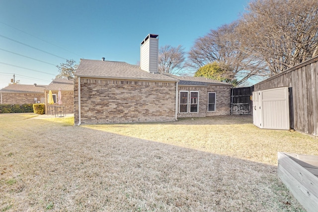 back of house with a lawn