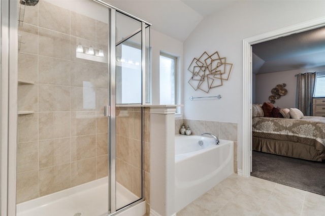 bathroom featuring tile patterned flooring, independent shower and bath, and vaulted ceiling