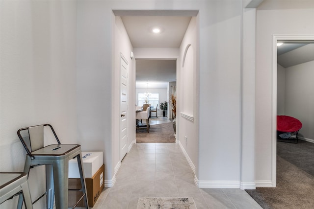 hallway featuring light carpet