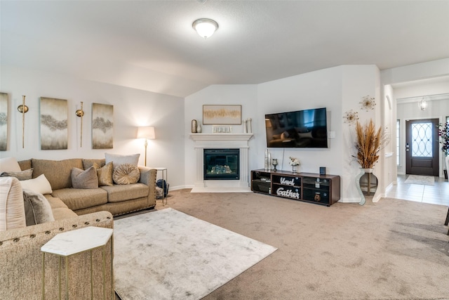 living room featuring lofted ceiling and carpet