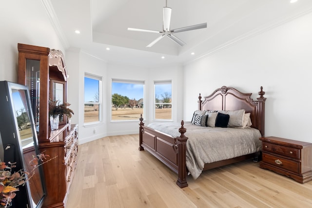 bedroom featuring recessed lighting, light wood finished floors, crown molding, and a raised ceiling