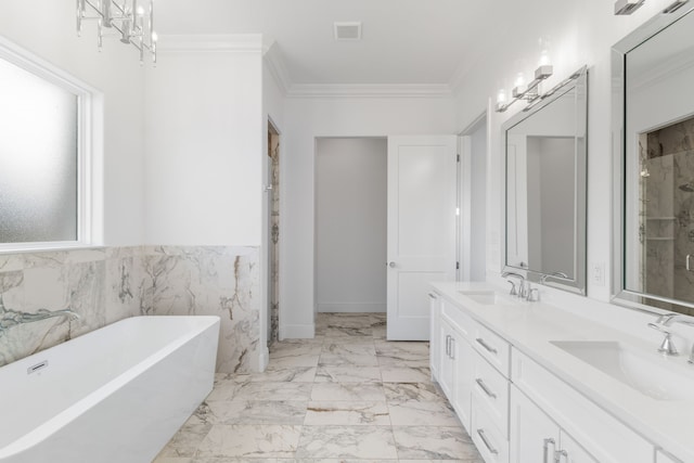 bathroom with marble finish floor, ornamental molding, a soaking tub, and a sink