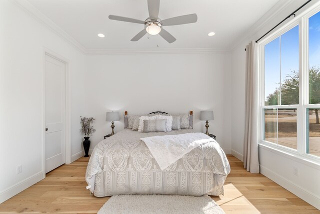 bedroom with light wood-type flooring, baseboards, recessed lighting, and crown molding