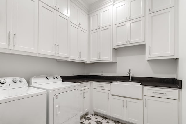 laundry room featuring washer and dryer, cabinet space, and a sink