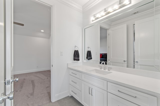 bathroom featuring baseboards, ornamental molding, vanity, and visible vents