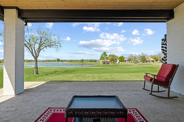 view of patio / terrace with view of golf course and a water view