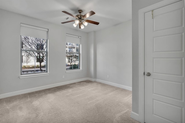 carpeted empty room featuring ceiling fan