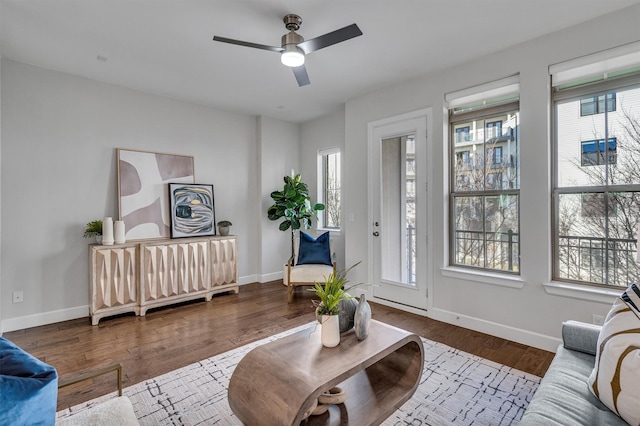 living room featuring hardwood / wood-style flooring, a healthy amount of sunlight, and ceiling fan