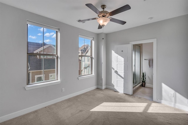 carpeted empty room featuring ceiling fan