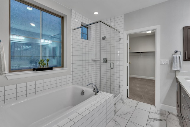 bathroom featuring vanity and shower with separate bathtub