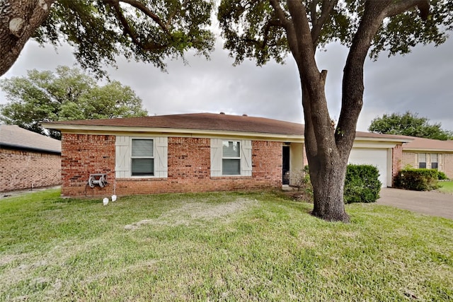 ranch-style house featuring a garage and a front yard