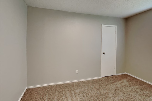 empty room with carpet and a textured ceiling