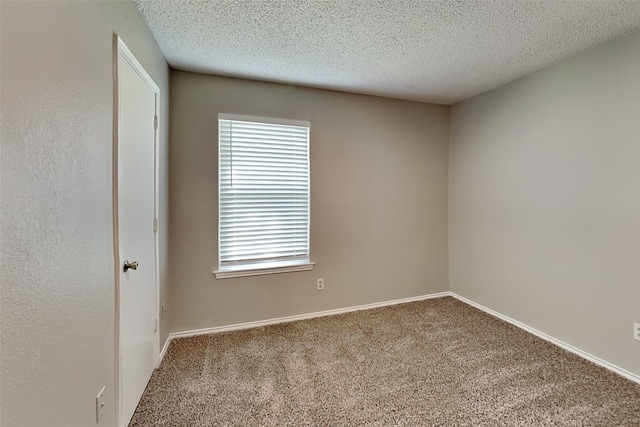 unfurnished room featuring carpet flooring and a textured ceiling