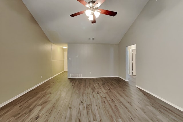 spare room featuring vaulted ceiling, light hardwood / wood-style floors, and ceiling fan