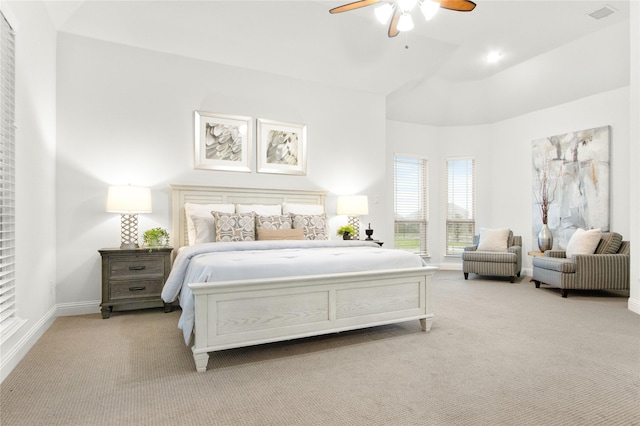 carpeted bedroom featuring a towering ceiling and ceiling fan