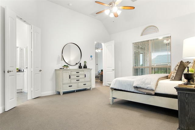 carpeted bedroom with lofted ceiling, ceiling fan, and ensuite bath