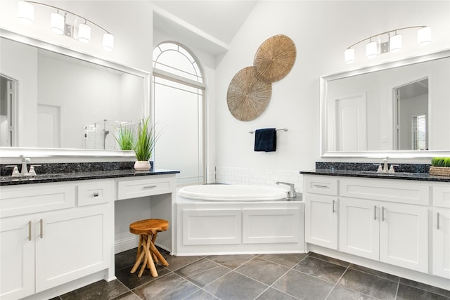 bathroom featuring a bathing tub, vanity, and high vaulted ceiling