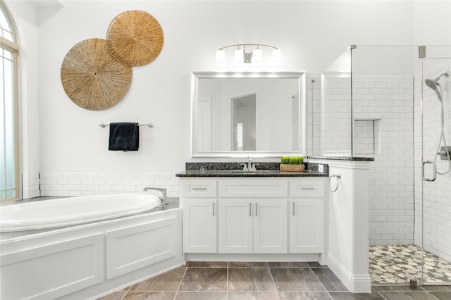 bathroom featuring vanity, independent shower and bath, and tile patterned flooring