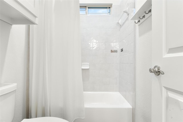 bathroom with shower / bath combination with curtain and toilet