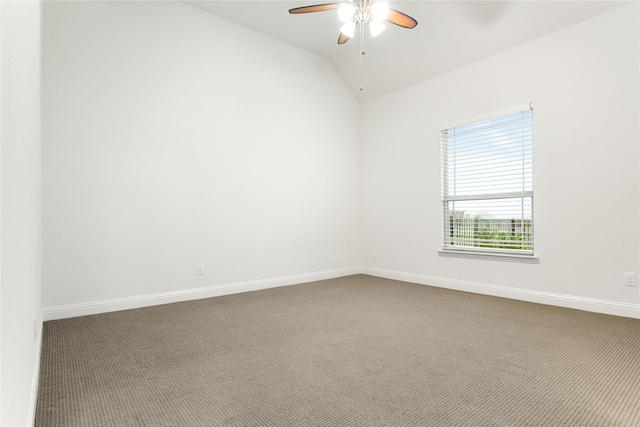 spare room featuring lofted ceiling, carpet flooring, and ceiling fan