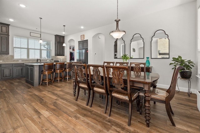 dining space featuring dark wood-type flooring and sink