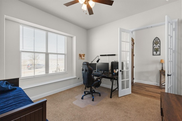 carpeted office space featuring french doors and ceiling fan