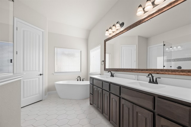 bathroom with plus walk in shower, lofted ceiling, tile patterned floors, and vanity