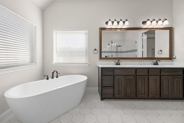 bathroom featuring independent shower and bath, vanity, lofted ceiling, and tile patterned flooring