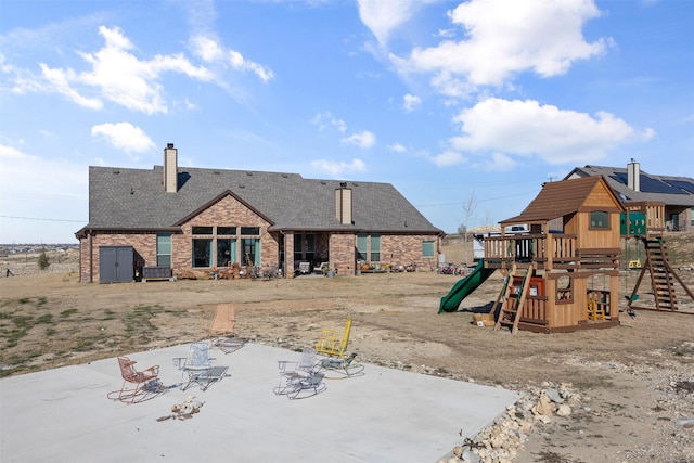 view of playground featuring a patio