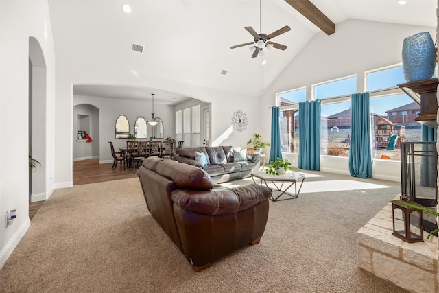 living room with light carpet, ceiling fan, high vaulted ceiling, and beamed ceiling