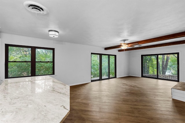 unfurnished room featuring dark wood-type flooring and ceiling fan