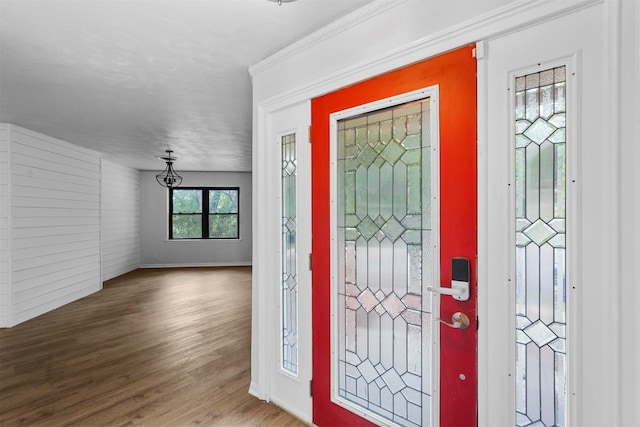 foyer featuring hardwood / wood-style flooring and ornamental molding