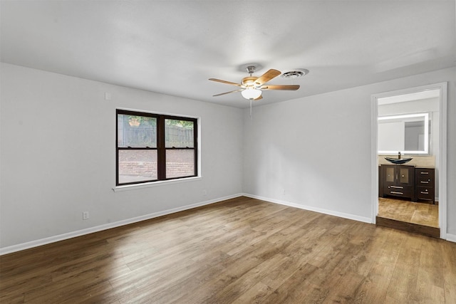 spare room with ceiling fan and light hardwood / wood-style floors