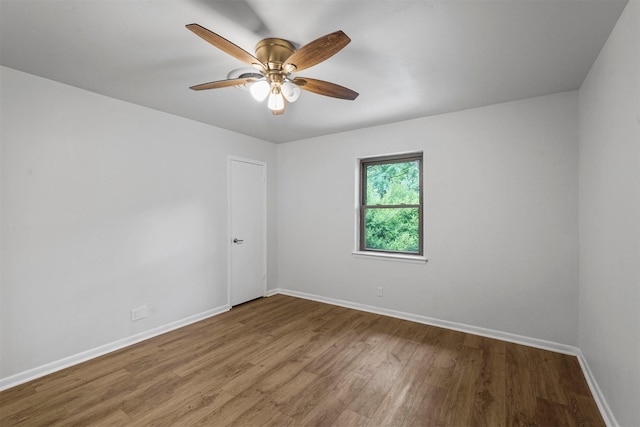 empty room with hardwood / wood-style flooring and ceiling fan