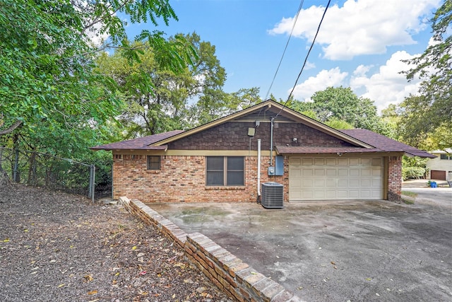 view of property exterior featuring a garage and central air condition unit