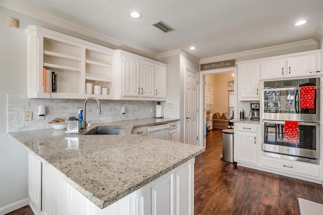 kitchen featuring white dishwasher, kitchen peninsula, double oven, and white cabinets