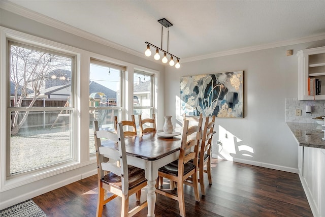 dining room with ornamental molding, dark wood-type flooring, and a wealth of natural light