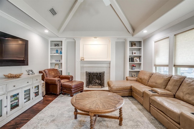 living room with vaulted ceiling with beams, built in shelves, a fireplace, and wood-type flooring