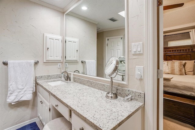 bathroom with crown molding, vanity, and a textured ceiling