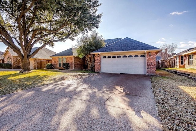 ranch-style home featuring a garage and a front lawn