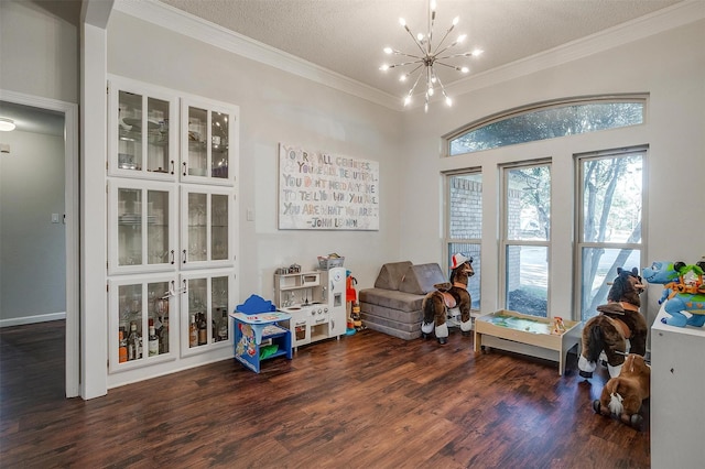 sitting room with an inviting chandelier, dark hardwood / wood-style floors, a textured ceiling, and crown molding