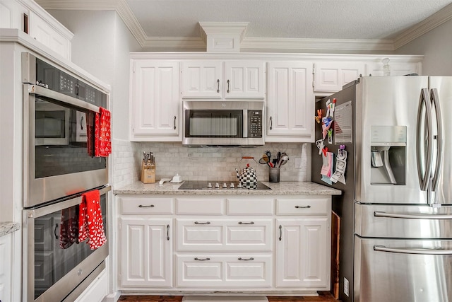 kitchen with stainless steel appliances, light stone countertops, white cabinets, and decorative backsplash