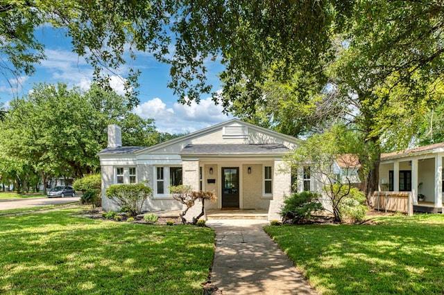 bungalow-style house featuring covered porch and a front lawn