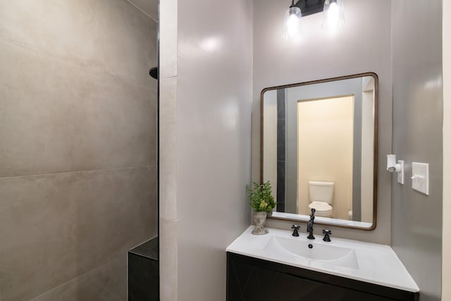 bathroom featuring vanity and toilet