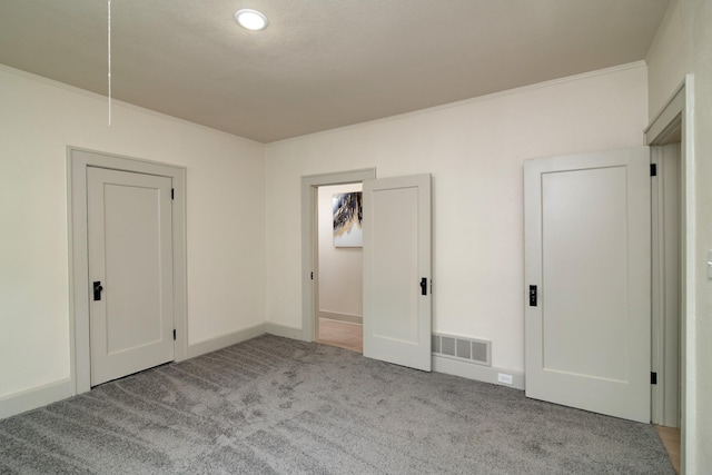 unfurnished bedroom featuring ornamental molding and light colored carpet