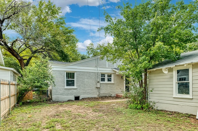 back of house with a lawn