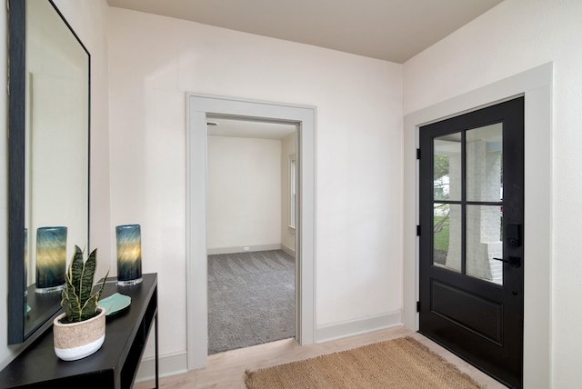 entryway featuring light colored carpet